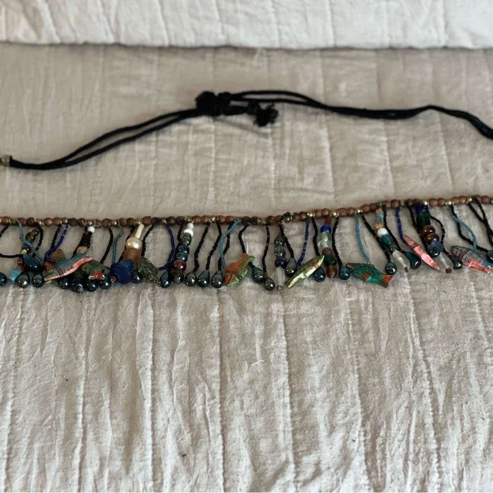 A tribal belly belt 46in, with wooden and glass beads with fish decor